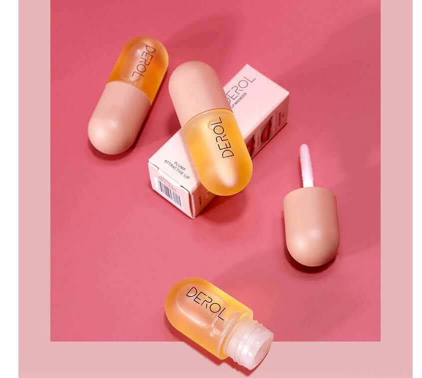 huile repulpante lèvres volume instantané - flacons et emballage sur fond rose