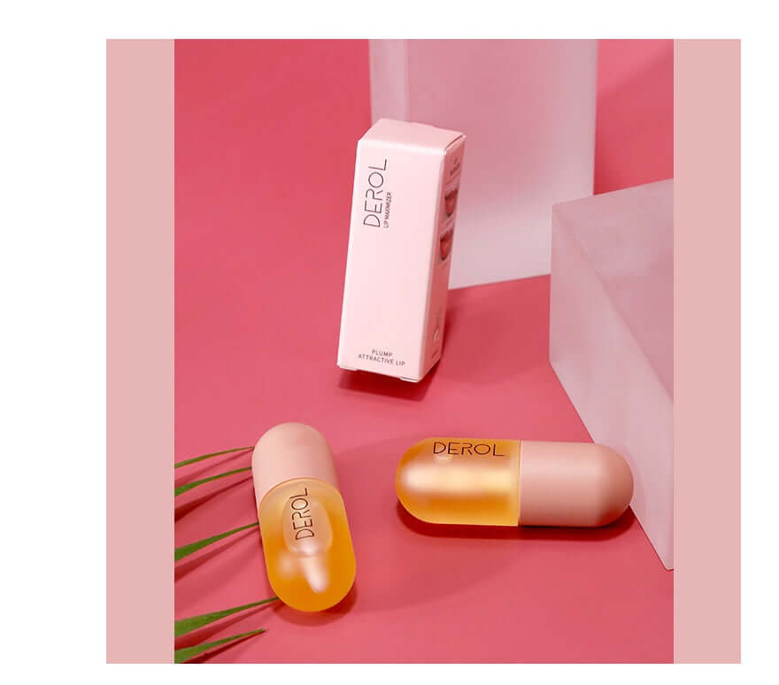 huile repulpante lèvres volume instantané - flacon et emballage sur fond rose