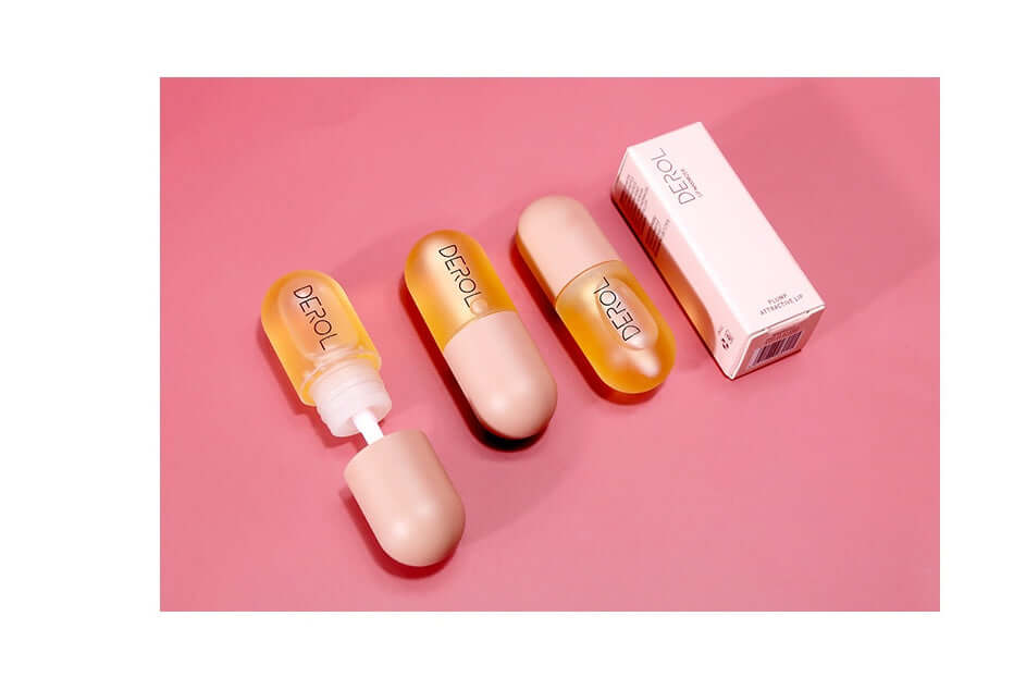 huile repulpante lèvres volume instantané en flacon, avec applicateur et emballage sur un fond rose